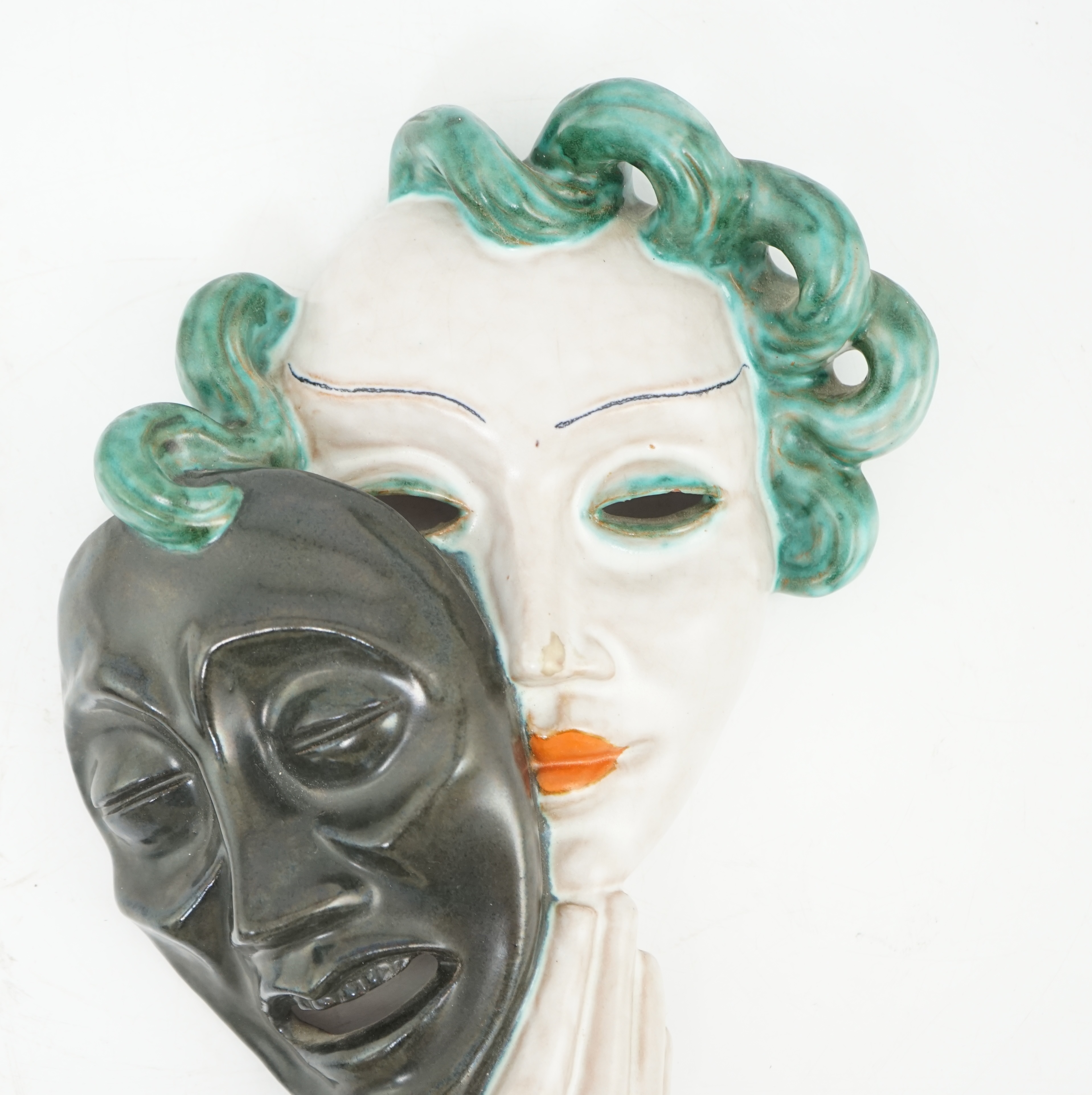 An Art Deco tin-glazed terracotta theatrical wall mask, by Goldscheider